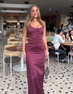 Woman in a purple dress standing in a restaurant setting